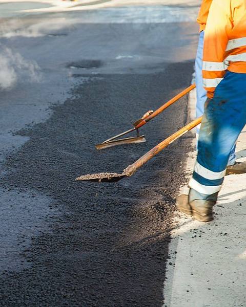 Crew laying fresh asphalt